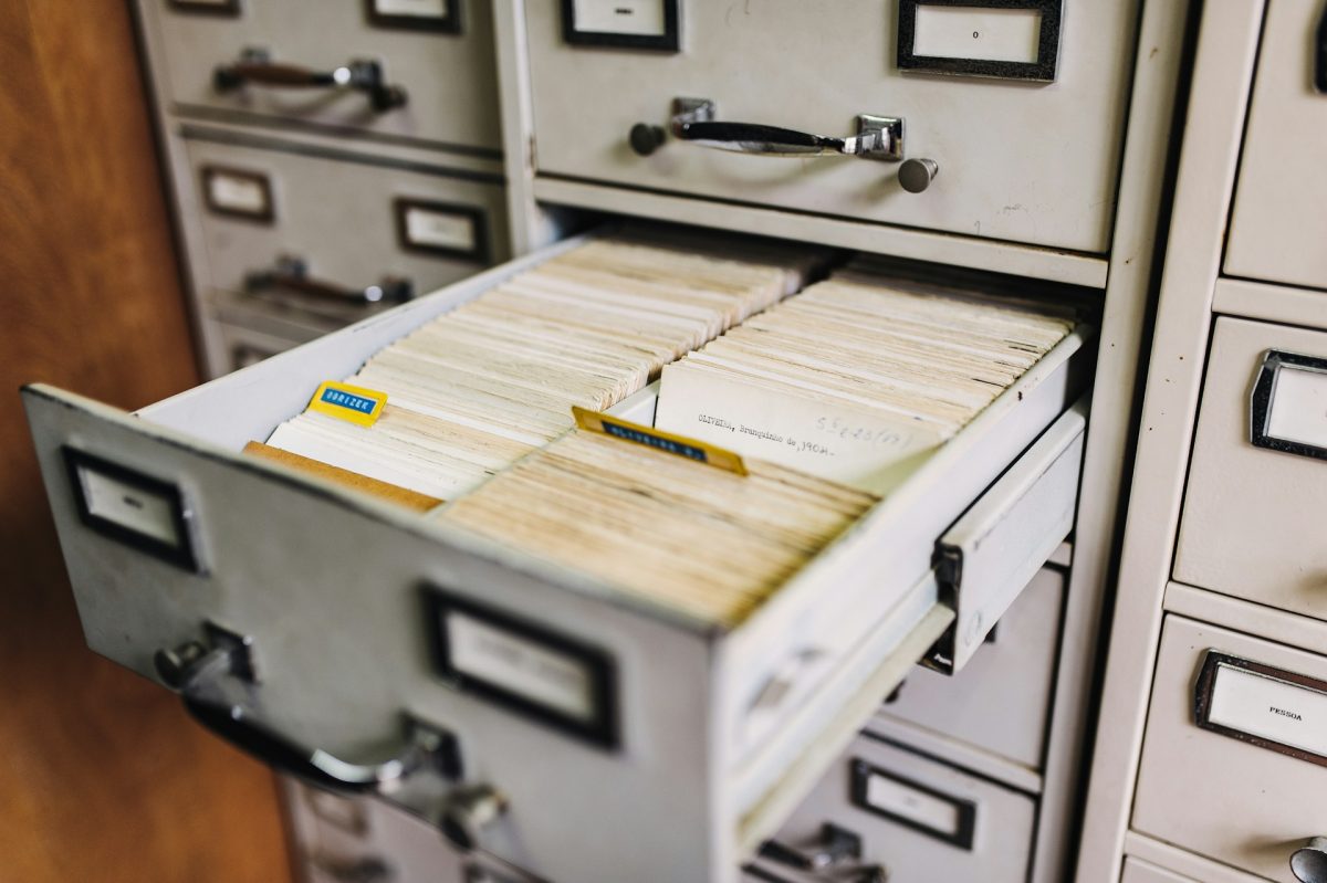 Open filing cabinet drawer with rows of index cards